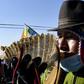 An Amauta, a priest of Bolivia's indigenous Aymara community, blows an instrument during an anti-government march