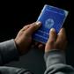 A man holds his work document at a job fair in 2019 in Rio de Janeiro, Brazil -- the country's unemployment rate has now risen to to 13.3%