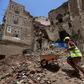 Yemeni labourers remove rubble ahead of restoration works on the site of a collapsed UNESCO-listed building following heavy rains in the Old City of the Yemeni capital Sanaa