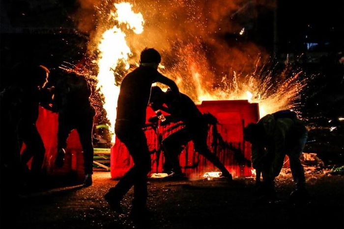 Demonstrators set a barricade on fire during a protest against police brutality in Cucuta, on Colombia's border with Venezuela