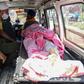 A man sits by the body of a relative who died after apparently drinking toxic moonshine. Dozens of people in Punjab's Tarn Taran district have died after consuming illicit booze in recent days