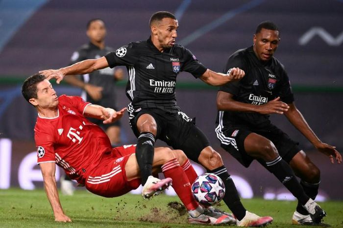 Lyon defender Fernando Marcal (C) battles with Robert Lewandowski in the Champions League semi-final against Bayern Munich