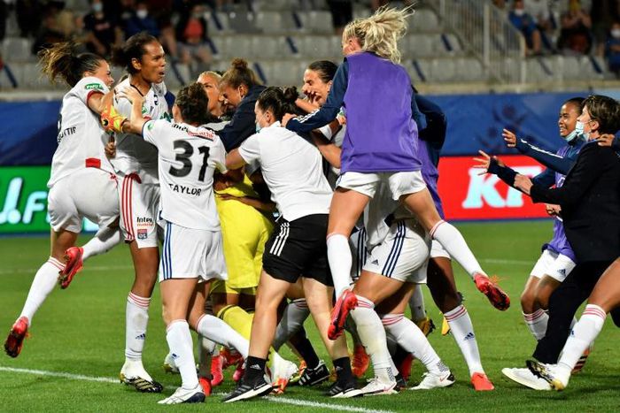 Lyon's players celebrate with Sarah Bouhaddi after she saved the key penalty