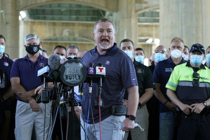 New York Police Benevolent Association President Mike O'Meara and representatives from other NYPD and law enforcement unions hold a news confenece at the Icahn Stadium parking lot on June 9