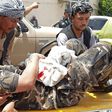 A wounded security staffer is carried by  stretcher to hospital after the Aybak car bomb