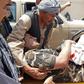 A wounded security staffer is carried by  stretcher to hospital after the Aybak car bomb