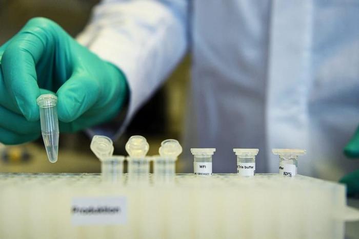 FILE PHOTO: Employee Philipp Hoffmann, of German biopharmaceutical company CureVac, demonstrates research workflow on a vaccine for the coronavirus (COVID-19) disease at a laboratory in Tuebingen, Germany, March 12, 2020. Picture taken on March 12, 202...