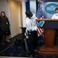 Cleaning staff disinfect the lectern in the White House Press Briefing Room