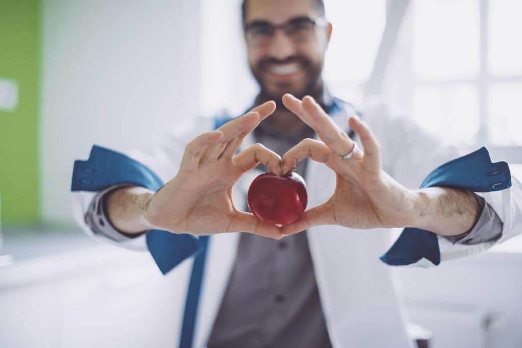 Holding a red apple