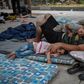 Around 100 mostly Afghan refugees have been camping in Athens under temperatures exceeding 30 degrees Celsius