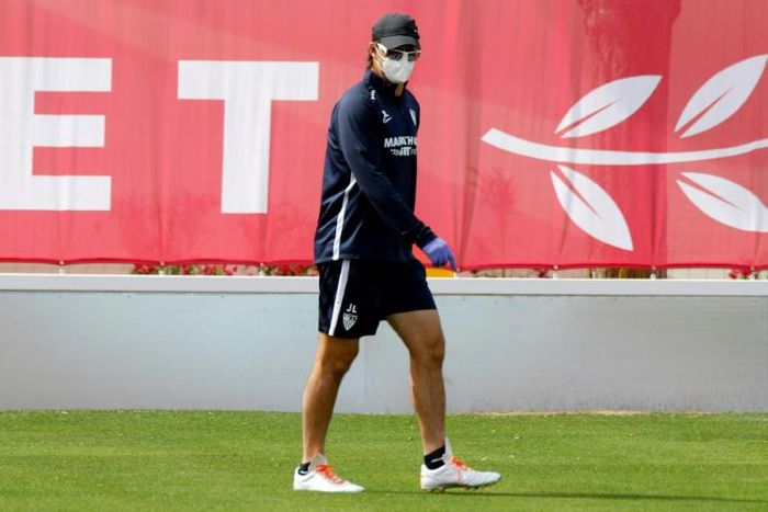 Big night: Sevilla coach Julen Lopetegui wearing a face mask while attending a training session