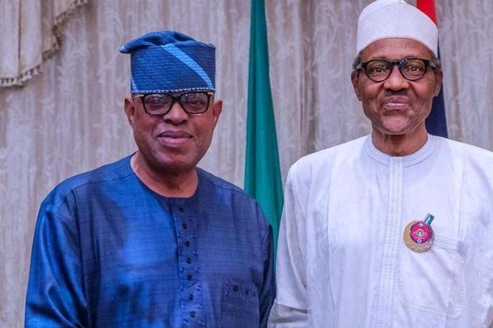 President Muhammadu Buhari rejoices with Sen. Gbenga Ashafa. [abusidiqu]
