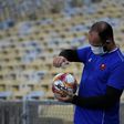 A ball boy disinfects the ball during a Carioca Championship 2020 football match between Flamengo and Bangu at the Maracana stadium, in Rio de Janeiro, Brazil, on June 18, 2020