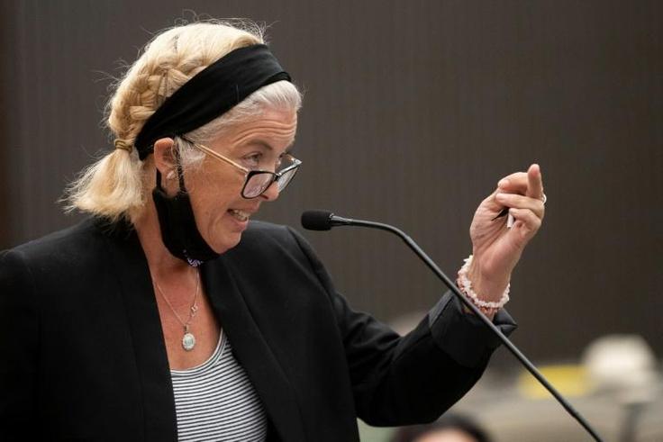 Patti Cosper, the daughter of rape survivor Patricia Murphy shows Joseph James DeAngelo the middle finger after reading a statement on her mother's behalf during the first day of victim impact statements at the Gordon D. Schaber Sacramento County Court...