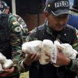 Anti-narcotics police officers prepare to incinerate cocaine at La Rinconada, in outskirts of La Paz, on December 5, 2019