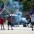 Supporters of US President Donald Trump wield signs and flags as they hold a Republican voter registration in Brownsville, Pennsylvania