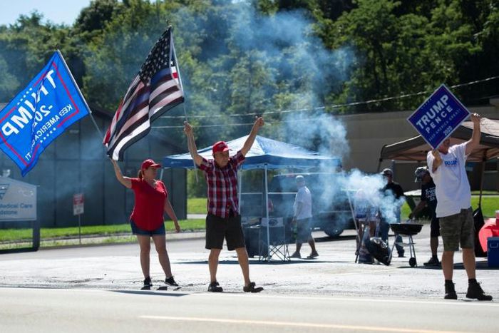 Supporters of US President Donald Trump wield signs and flags as they hold a Republican voter registration in Brownsville, Pennsylvania