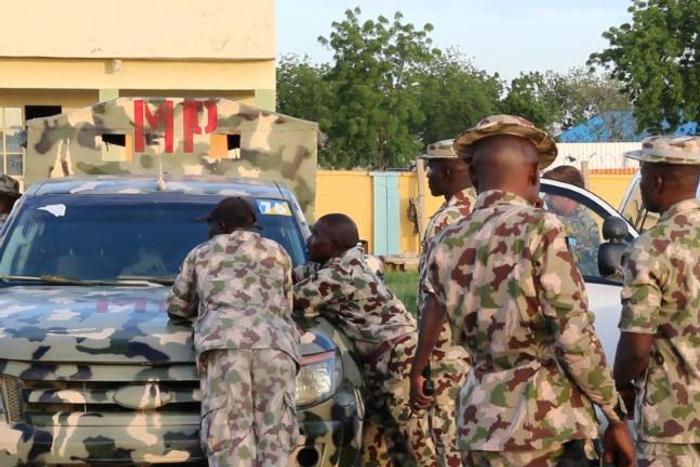 Nigerian soldiers stop aid workers in Maiduguri last year, as part of a clampdown Human Rights Watch says has the humanitarian response more difficult