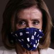 US House speaker Nancy Pelosi, seen wearing a protective mask at a May 7, 2020 briefing, has urged President Donald Trump to set an example by doing the same