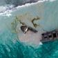 The split was caused by a crack in a cargo hold on the stern side, the ship's operator said