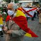 Demonstrators wrapped in Spanish flags protest at what rightwing parties have dubbed a "brutal confinement" after a fifth state of emergency extension