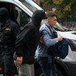 A law enforcement officer detains a student in Minsk on Tuesday
