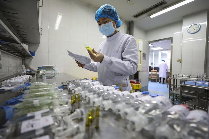 In this Sunday, Feb. 16, 2020, photo, a nurse prepares medicines for patients at Jinyintan Hospital designated for new coronavirus infected patients, in Wuhan in central China's Hubei province. China reported thousands new virus cases and more deaths i...