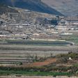 A general view of fields and buildings outside Kaesong in North Korea, seen across the Demilitarized Zone from the South Korean island of Ganghwa