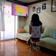 High school student Vanessa Villegas takes a class in front of her television at her house in Mexico City on August 24, 2020