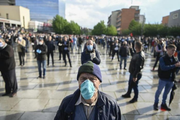 Supporters of the left-wing Vetevendosje party braved rain as they stood with masks and gloves in evenly-spaced rows in the centre of Pristina