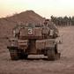Israeli infantry soldiers gather next to tanks and an armoured personnel carrier near the Israeli border with the Gaza Strip on Sunday