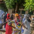 Voters stand apart outside a polling station in Cotonou