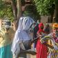 Voters stand apart outside a polling station in Cotonou