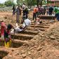 Workers dig graves at the Caminos del Cielo cemetery in Managua on May 23, 2020