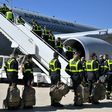 French Securite Civile (Civil Security) personnel board a plane near Paris, as France sends search and rescue experts aboard three military planes loaded with a mobile clinic and medical equipment to Beirut, a day after a powerful explosion there