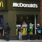 Delivery riders queue  outside a McDonald's in London; the company is facing a sexual harassment complaint filed at the OECD by an international coalition of labor unions