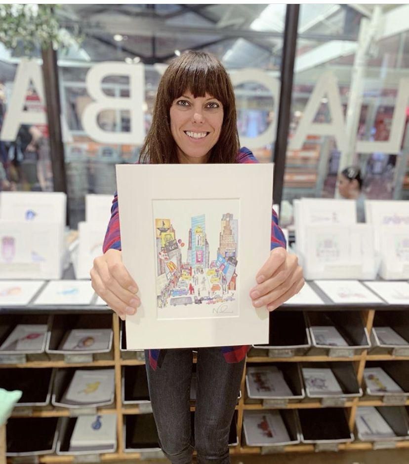 Nadia and her illustrations in store.