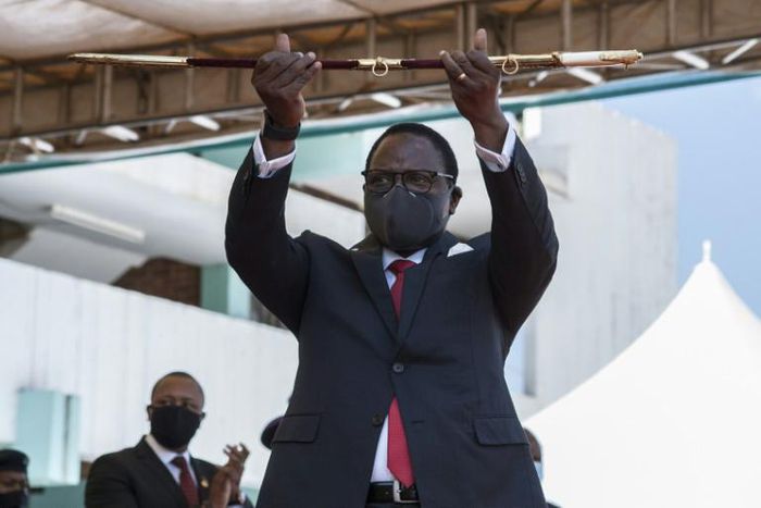 Malawi's new President Lazarus Chakwera shows the sword of office