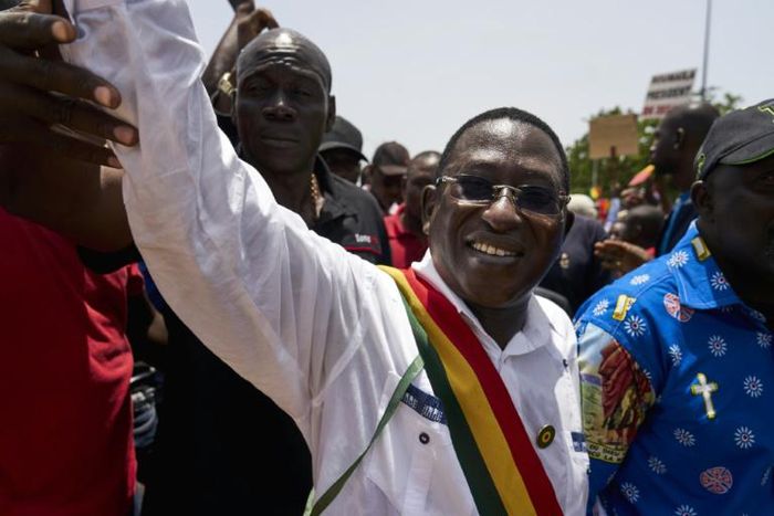 Soumaila Cisse greets supporters on a march in Bamako in 2018