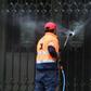 A worker cleans the entrance to St Patrick's Cathedral in Melbourne after it was vandalised following Cardinal George Pell's release from prison
