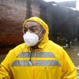 An employee of the Public Works Ministry is seen in the flooded Santa Lucia colony in Ilopango, El Salvador, during Tropical Storm Amanda