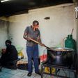 Volunteers from the African Diaspora Forum prepare hot meals for the daily food distribution in Johannesburg