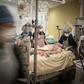 Doctors and nurses tending to a COVID-19 patient in the intensive care unit at the Lariboisiere hospital in Paris