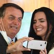 Analysts say the downturn has been mitigated by a stimulus package decided on by the government of Brazilian President Jair Bolsonaro, shown here posing with a doctor before the event "Brazil beating COVID-19" at Planalto Palace on August 24, 2020