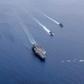 Aircraft carriers the USS Nimitz and USS Ronald Reagan sailing in Asia in July -- Washington is pushing back against Beijing over its military buildup in the South China Sea