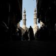 People shop on roofed Khayamiya Street in the old city of the Egyptian capital Cairo; A young Egyptian filmmaker imprisoned for directing a music video critical of President Abdel Fattah al-Sisi has died in a Cairo jail