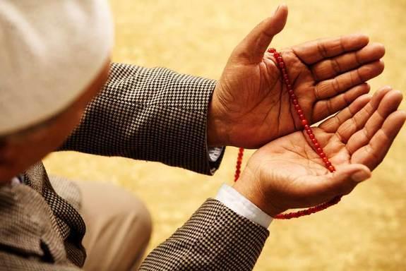 A Muslim man looks poised for prayer.
