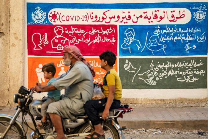 A mural in the Kurdish-majority city of Qamishli in northeastern Syria urges people to protect themselves from the virus as part of a campaign by the UN childre's fund UNICEF and the World Health Organization