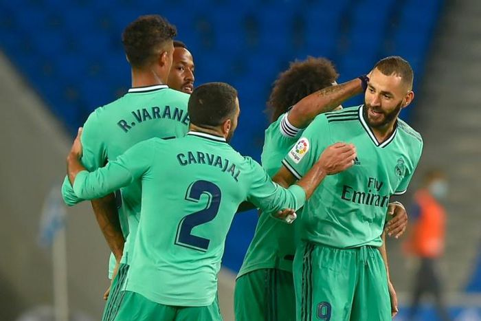 Karim Benzema (R) celebrates with his Real Madrid teammates after scoring in Sunday's 2-1 win at Real Sociedad which put them back in command in the Spanish title race