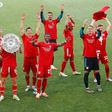 Bayern Munich players celebrate with the Bundesliga trophy on Saturday
